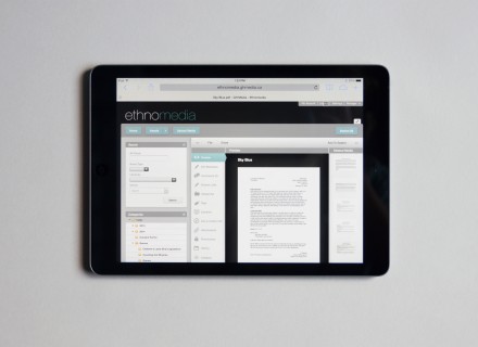 Photograph of iPad on a grey background showing the ethnomedia website on its screen.