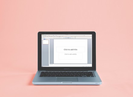 Photo of Macbook Pro with powerpoint open on the screen.